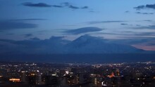 "Captivating Day To Night Time Lapse Of Yerevan City Center Against Snow Covered Mount Ararat Backdrop On A Windy Day, With Moving Clouds. Stunning Urban Landscape, Uhd, 4k, 3840, 2160