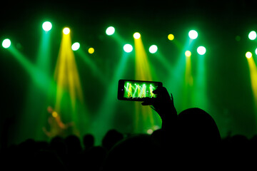 Wall Mural - Making photo with smartphone during a concert to share the moment with friends on social networks.