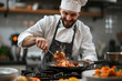 A chef wearing cooking uniform while preparing delicious gourmet dish for dinner service at restaurant
