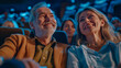 © olvius - elderly man and woman watching a movie in a cinema laughing, rejoicing
