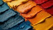 Close up view of a rainbow of colorful paint swatches overlapping and blending together