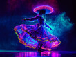 Cinco de Mayo female dancer in neon light. Beautiful female model in traditional costume and sombrero dancing on the dark background.