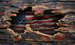 Patriotic American flag ripped through wood
