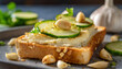 Close-up of toasted bread with cashew cheese spread with roasted garlic and thinly sliced cucumber.