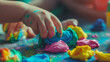 Child hands playing with colorful clay. Homemade plastiline. Plasticine. play dough. Girl molding modeling clay. Homemade clay.