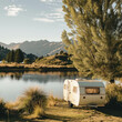 Embrace nature's charm with a camper trailer parked beside a lake in the grassy wilderness. Enjoy the tranquil lakeside retreat. AI generative technology enriches the natural setting.