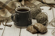 Cup of tea with tea bag and breakfast biscuits. Breakfast on a wooden background. Tea and cookies next to a blanket create coziness.