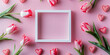 A flat lay  of pink tulips and white hearts with a blank square frame on pink background , banner, copy space