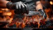 © JovialFox - Grill restaurant kitchen. close up A chef in black cooking gloves uses a knife to cut smoked pork ribs.