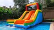 © Rohit - children playing on inflatable bounce house water slide with colorful bouncy castle slide in the backyard and outdoor playground photo