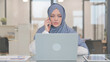 © stockbakers - Arab Woman Talking on Phone at Work