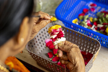 Wall Mural - Woman making garlands at ISKCON temple in Juhu, Mumbai, India