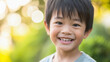 Little Asian boy close up portrait, outdoors, copy space