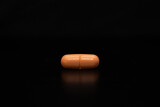 Fototapeta  - close up with a pill on a black background