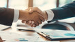 © Laura - A close-up of a handshake between an entrepreneur and an investor, sealing a deal for mutual growth and success