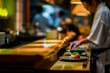 Sushi chef prepares dishes before serving in a restaurant, modern kitchen decoration for menu, blurred background and selective focus on dish on counter