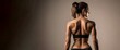 Back view of a fitness woman with well defined fit body for gym, fitness and healthy concepts with blank space for text