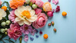 A bright and cleanly arranged assortment of various colorful flowers on a pale blue background