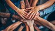 © OMD - Top-down view of diverse hands together in a symbol of unity