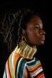 Elegant Profile of Young Woman with Textured Hair and Colorful Sweater Banner