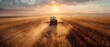 A tractor harvesting crops in a large field at sunset. Concept Agriculture, Farming, Sunset, Harvesting, Tractor