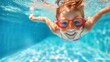 © CinimaticWorks - joyful girl kid learning to swim and dive underwater in pool. active lifestyle and swimming lessons for child on summer vacation