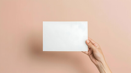 Wall Mural - mockup white sheet of paper in hand on pink background