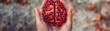 Hand holding a brain-shaped pomegranate, seeds of wisdom through healthy eating