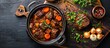 © FryArt - A pot filled with German style braised beef cheeks in a rich red wine sauce, cooked with tender carrots and onions.