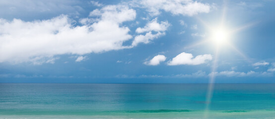 Wall Mural - Sea and sun on blue sky . Wide photo.