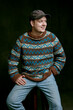 © Joel Forsman/Stocksy - a nordic man wearing a knitted sweater, jeans, and a cap.