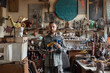© Demetr White/Stocksy - needleworker stands in the workshop
