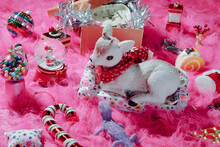 Christmas Ornaments And Toys Scattered On A Pink Long-hair Rug