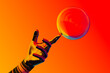 © Marcos Osorio/Stocksy - A hand holding a soap ball in front of a rainbow colored background