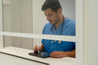© nomad studio/Stocksy - doctor writing on a tablet computer in a hospital