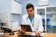 © nomad studio/Stocksy - doctor using a tablet computer in a medical office