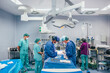 © VICTOR TORRES/Stocksy - Surgical team performing an operation in a modern OR