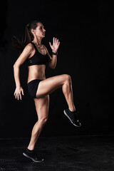 Sticker - Fitness, gym and woman athlete in studio running for competition, race or marathon training. Sports, workout and female runner with cardio exercise for health or wellness by dark black background.