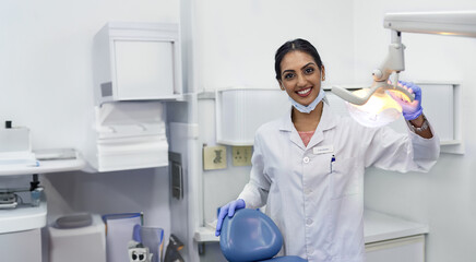 Wall Mural - Dentist, portrait and woman by xray machine with smile for mouth care, dental health and service. Medical professional, happy and equipment in office for oral hygiene, dentistry and examination