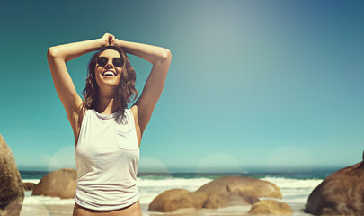 Wall Mural - Smile, travel and woman at beach on summer vacation, adventure or holiday with freedom in Mexico. Happy, sunglasses and young female person by ocean, sea and blue sky with mockup on weekend trip.