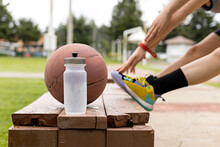 Close-up Of An Amphora And A Basketball On A Wooden Bench In A Park