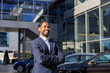 © Jovo Jovanovic/Stocksy - Smiling confident sales executive at car dealership