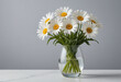 A photo of white daisies in a glass vase, in a minimalistic style, with a clean background