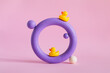 © Julia Potato/Stocksy - Violet colored torus with rubber ducks on pink paper background