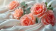 An arrangement of pink roses on white silk