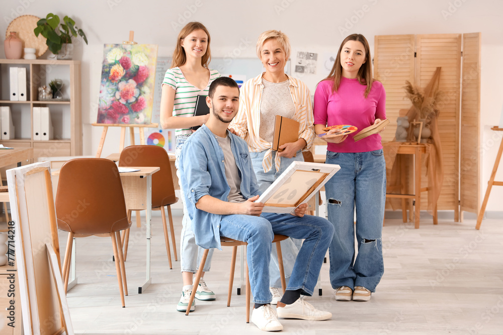 Female art teacher with students at school