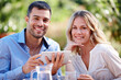 © peopleimages.com - Happy couple, portrait and tablet in garden for breakfast, internet and communication with family. Male, female and outdoors at home for mobile, meme and social media scrolling for online platform.