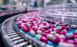 Automated pharmaceutical production line producing pink and white capsules. Manufacturing process of medical pills on a conveyor belt. Pharmaceutical industry concept.