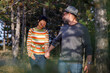 © Jovo Jovanovic/Stocksy - Happy couple walking in forest on vacation