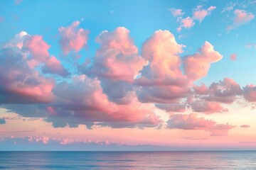 Wall Mural - Cirrus clouds tinted pink by the sun at sunset over a calm blue ocean